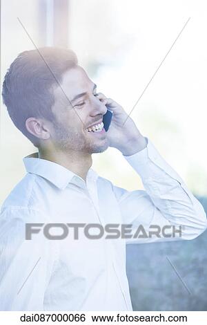 Stock Photograph - Businessman receiving good news phone call. Fotosearch