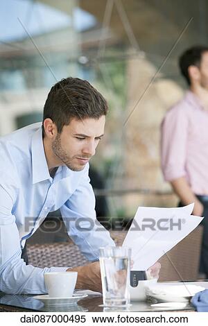 Businessman reviewing documents View Large Photo Image Stock Photography - Businessman reviewing documents. Fotosearch