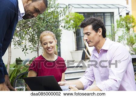 Businessman sharing ideas with colleagues View Large Photo Image Stock Image - Businessman sharing ideas with colleagues. Fotosearch