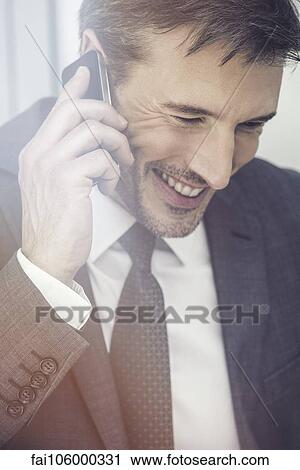 Businessman talking on cell phone, smiling View Large Photo Image Stock Image - Businessman talking on cell phone, smiling. Fotosearch