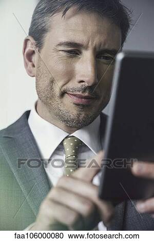 Businessman using digital tablet View Large Photo Image Stock Image - Businessman using digital tablet. Fotosearch