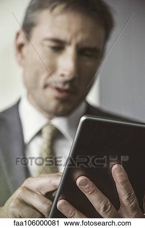 Businessman using digital tablet View Large Photo Image Stock Image - Businessman using digital tablet. Fotosearch