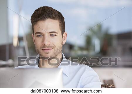 Businessman using laptop computer outdoors View Large Photo Image Stock Photo - Businessman using laptop computer outdoors. Fotosearch