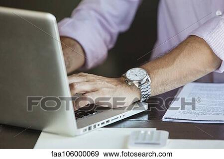 Businessman using laptop computer, cropped View Large Photo Image Stock Photo - Businessman using laptop computer, cropped. Fotosearch
