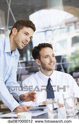 Stock Image - Businessmen collaborating. Fotosearch