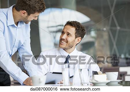 Stock Photograph - Businessmen collaborating. Fotosearch