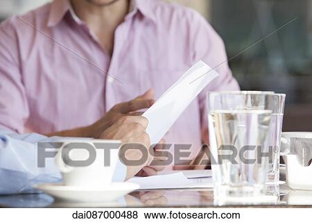 Businessmen discussing business document View Large Photo Image Stock Photo - Businessmen discussing business document. Fotosearch