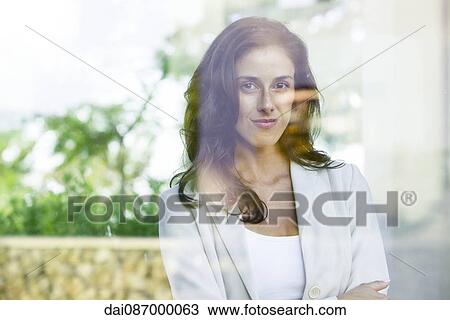 Businesswoman looking out of window from office View Large Photo Image Stock Image - Businesswoman looking out of window from office. Fotosearch