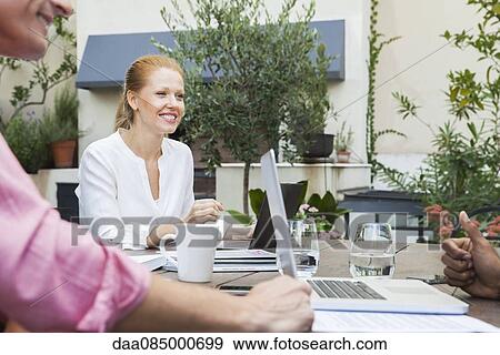 Stock Photo - Businesswoman meeting with colleagues. Fotosearch