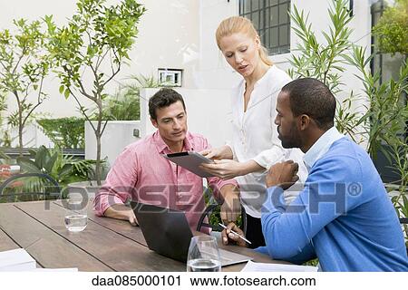 Businesswoman presenting idea at team meeting View Large Photo Image Stock Image - Businesswoman presenting idea at team meeting. Fotosearch