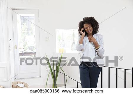 Stock Photograph - Businesswoman talking on cell phone. Fotosearch
