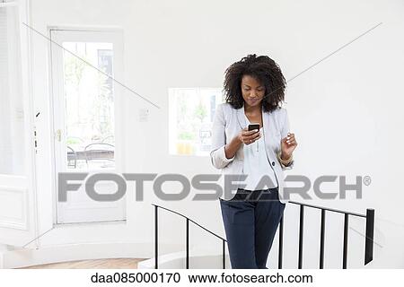 Businesswoman text messaging on cell phone View Large Photo Image Stock Image - Businesswoman text messaging on cell phone. Fotosearch