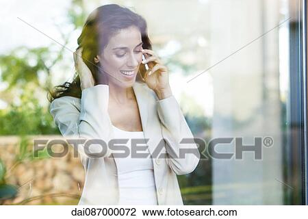 Businesswoman using cell phone in office View Large Photo Image Stock Image - Businesswoman using cell phone in office. Fotosearch
