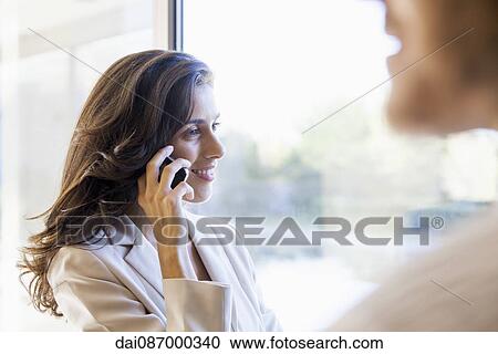 Businesswoman using cell phone View Large Photo Image Stock Image - Businesswoman using cell phone. Fotosearch