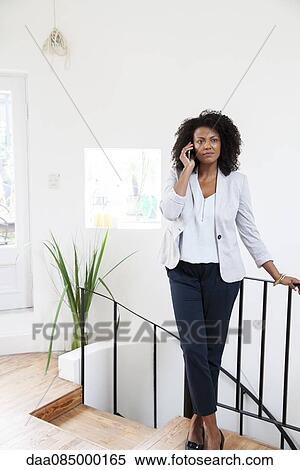 Stock Photography - Businesswoman using cell phone. Fotosearch