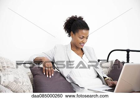 Stock Image - Businesswoman using laptop computer. Fotosearch