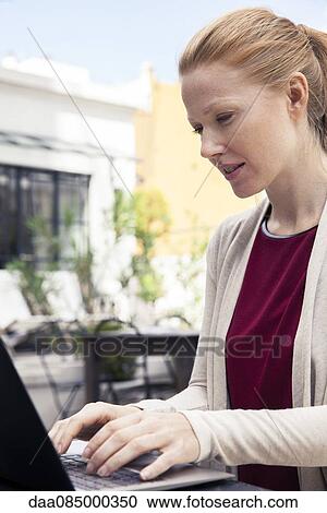 Businesswoman using laptop computer View Large Photo Image Stock Image - Businesswoman using laptop computer. Fotosearch