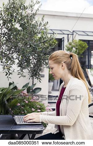 Stock Image - Businesswoman using laptop computer. Fotosearch
