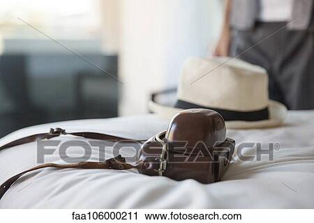 Camera and hat on bed View Large Photo Image Stock Image - Camera and hat on bed. Fotosearch