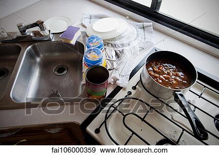 Stock Photo - Canned soup cooking on stovetop in motor home. Fotosearch