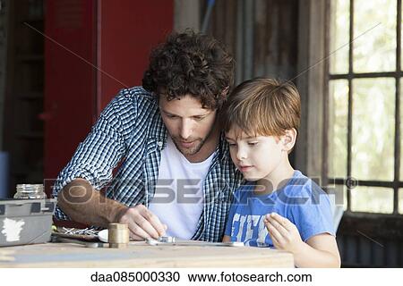 Child helping his father in workshop View Large Photo Image Stock Image - Child helping his father in workshop. Fotosearch