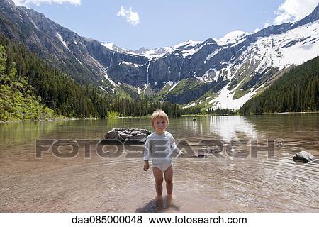 Child wading in water at Glacier National Park, Montana, USA View Large Photo Image Stock Photo - Child wading in water at Glacier National Park, Montana, USA. Fotosearch