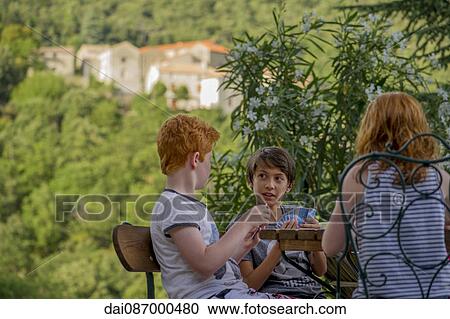 Children playing card game outdoors View Large Photo Image Stock Image - Children playing card game outdoors. Fotosearch