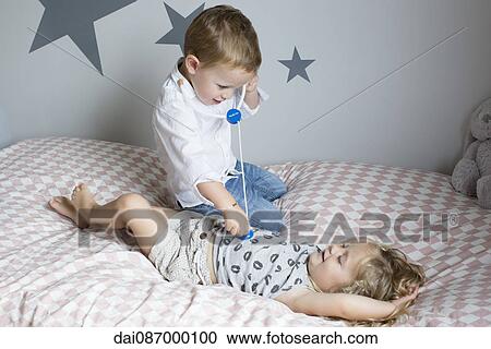 Children playing doctor with toy stethoscope View Large Photo Image Stock Image - Children playing doctor with toy stethoscope. Fotosearch
