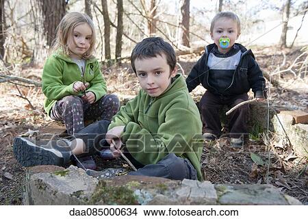 Picture - Children playing in woods. Fotosearch