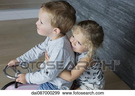 Children riding together on toy car View Large Photo Image Stock Photo - Children riding together on toy car. Fotosearch