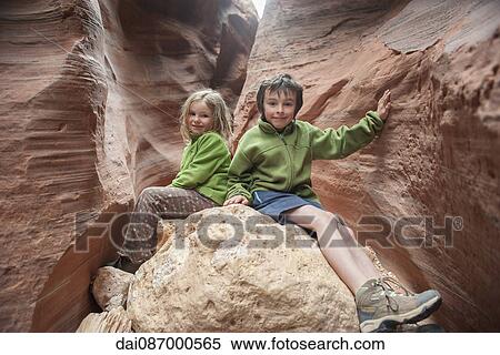 Children sitting on rock formation in Utah, USA View Large Photo Image Stock Photography - Children sitting on rock formation in Utah, USA. Fotosearch