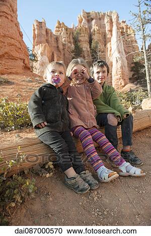 Children sitting on tree trunk at Bryce Canyon National Park, Utah, USA View Large Photo Image Stock Image - Children sitting on tree trunk at Bryce Canyon National Park, Utah, USA. Fotosearch