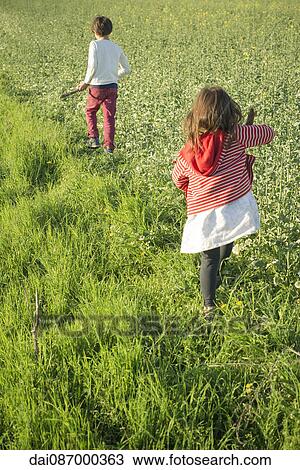 Children walking in field, rear view View Large Photo Image Stock Image - Children walking in field, rear view. Fotosearch