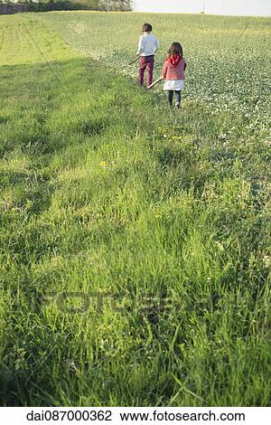 Children walking in field View Large Photo Image Stock Image - Children walking in field. Fotosearch