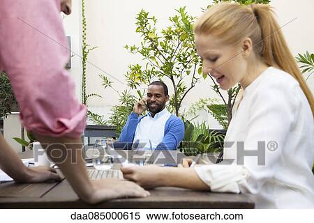 Colleagues chatting View Large Photo Image Stock Photography - Colleagues chatting. Fotosearch