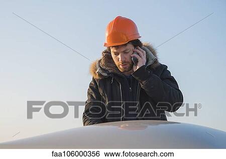 Construction worker talking on cell phone View Large Photo Image Stock Photograph - Construction worker talking on cell phone. Fotosearch