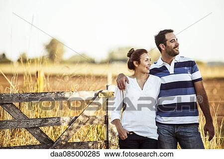 Couple admiring view of countryside View Large Photo Image Stock Photography - Couple admiring view of countryside. Fotosearch