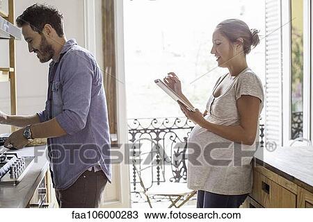 Couple at home together in kitchen View Large Photo Image Stock Image - Couple at home together in kitchen. Fotosearch