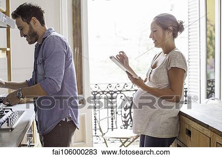 Couple at home together in kitchen View Large Photo Image Stock Image - Couple at home together in kitchen. Fotosearch