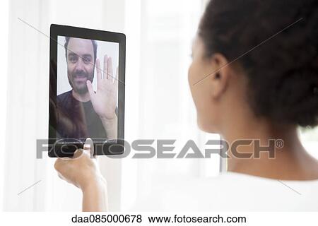 Couple doing video chat View Large Photo Image Stock Photo - Couple doing video chat. Fotosearch