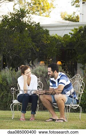 Couple enjoying tranquility of their backyard View Large Photo Image Stock Image - Couple enjoying tranquility of their backyard. Fotosearch
