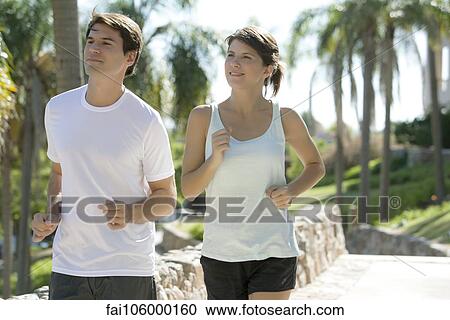 Couple jogging together in park View Large Photo Image Stock Image - Couple jogging together in park. Fotosearch
