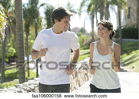 Couple jogging together in park View Large Photo Image Stock Photo - Couple jogging together in park. Fotosearch