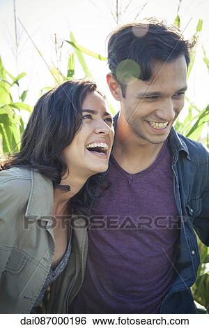 Stock Photograph - Couple laughing together outdoors. Fotosearch