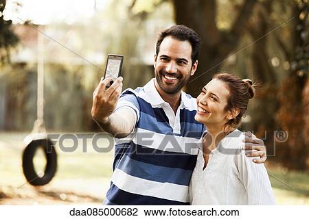 Couple posing for selfie View Large Photo Image Stock Image - Couple posing for selfie. Fotosearch