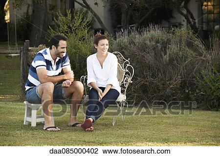 Stock Image - Couple relaxing together outdoors. Fotosearch