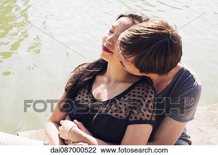 Couple relaxing together outdoors View Large Photo Image Stock Image - Couple relaxing together outdoors. Fotosearch