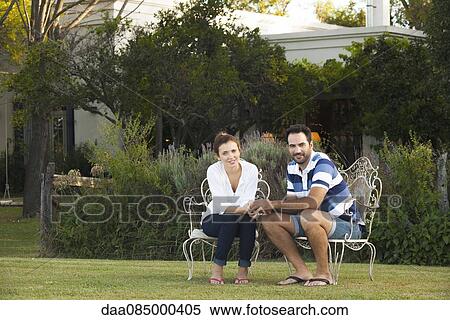 Couple relaxing together outdoors, portrait View Large Photo Image Stock Photography - Couple relaxing together outdoors, portrait. Fotosearch