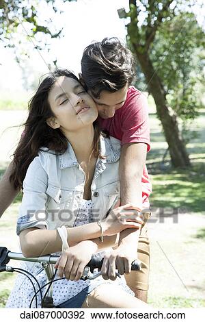 Couple riding bicycle together View Large Photo Image Stock Image - Couple riding bicycle together. Fotosearch