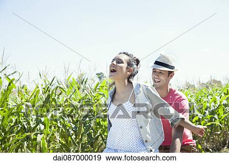 Couple riding bike together, woman with arms outstretched View Large Photo Image Stock Photo - Couple riding bike together, woman with arms outstretched. Fotosearch